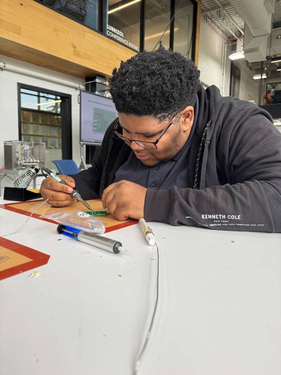 A student in the MAGNET Summer Manufacturing Academy takes part in a soldering course in the advocacy group’s headquarters in Hough.