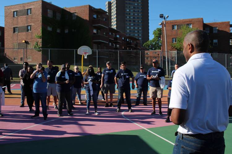 Spectrum group vice president of community impact Rahman Khan, holds a rally with employee volunteers in 2022 to celebrate the new Spectrum Community Center Assist partnership with CMHA Lakeview Terrace. Volunteers repaired and enhanced Lakeview Terrace.