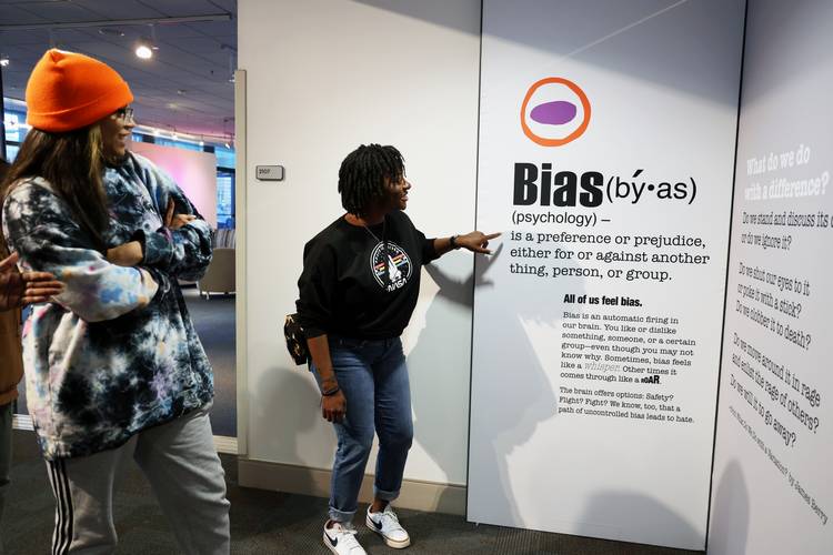 Visitors study the definition of 'Bias.'