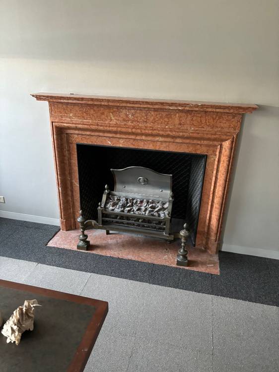 A fireplace in a smaller room.