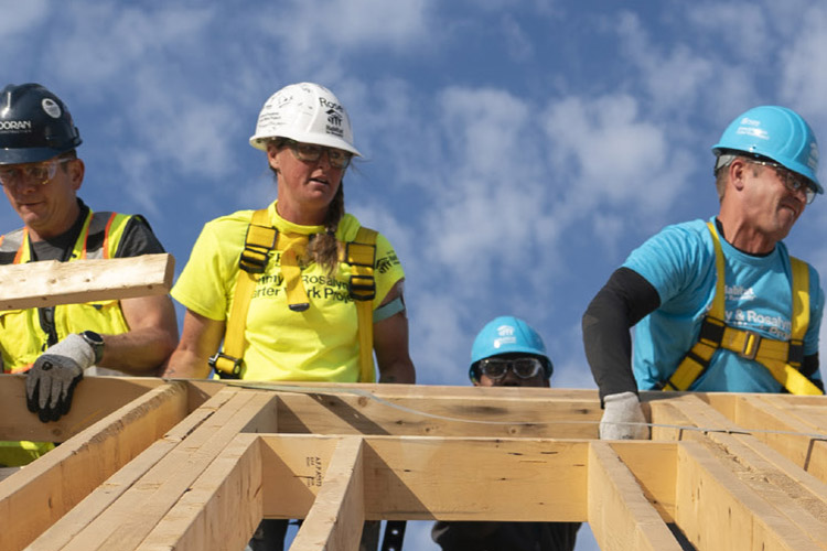 Volunteers work on a construction project.