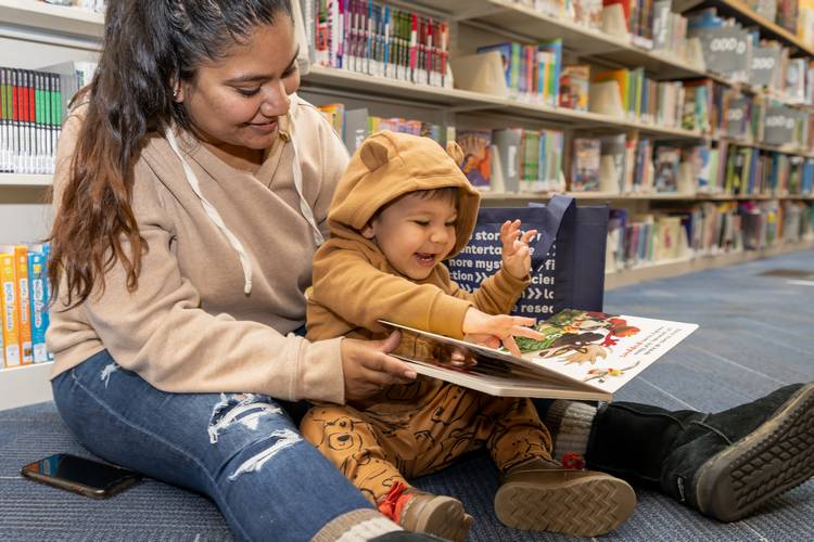 A mother reads with her child at CCPL.