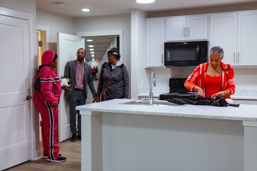 Guests tour an apartment unit during the Nobility Court ribbon cutting ceremony.