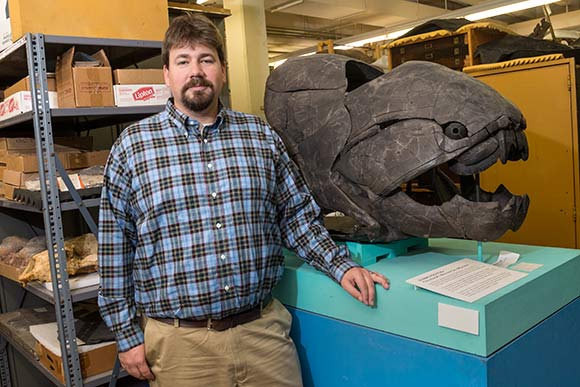 Dr. Andy Jones with Dunkleosteous Terrelli Fossil
