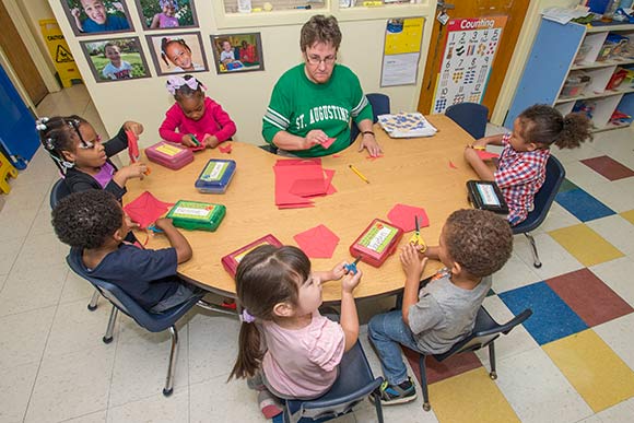 Teacher Lynda Boriska working with Pre4CLE students at St. Augustine Child Enrichment Center