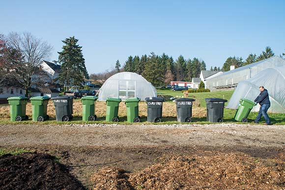 Chris Bond, Farm Horticulturist at CWRU Squire Valleevue Farm empties the waste brought in for composting