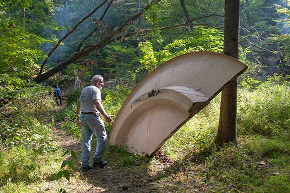 Paul Beno points out part of a dumped satellite dish