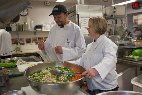 Case Manager Shelly Bishop workis with Erik Wells, trainee in the Vocational Training Center program in Cornucopia's state-of-the-art commercial kitchen