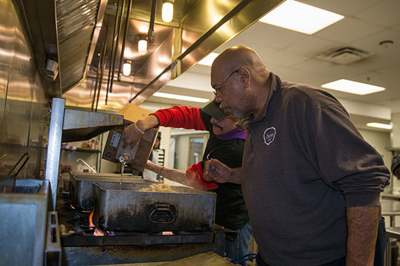 Brad Taylor, Kitchen Manager, works with a trainee in the Culinary Training Program class at Lutheran Metropolitan Ministries