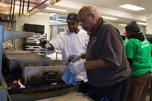 Brad Taylor, Kitchen Manager, works with a trainee in the Culinary Training Program at Lutheran Metropolitan Ministries