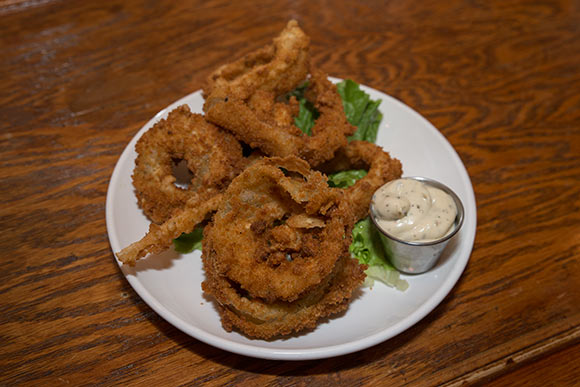 Onion rings served up fresh and crispy at The Rib Cage Smokehouse and Bar
