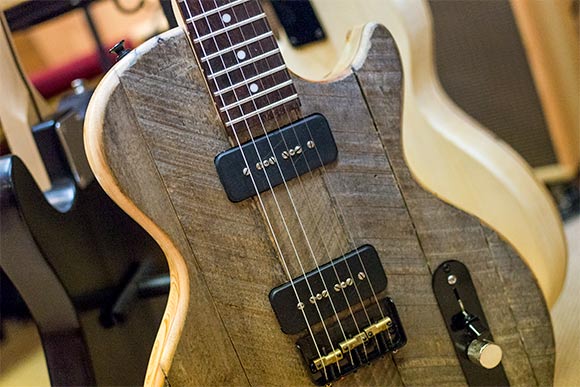 <span class="content-image-text">One of his guitars made with apple crate wood</span>