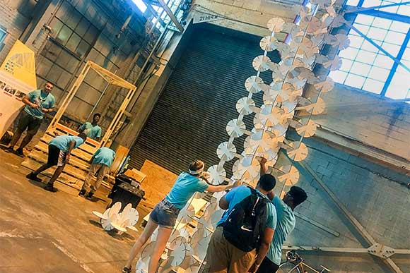 (MOOS) kids at IngenuityFest making towering art sculptures out of interlocking would-be flower discs
