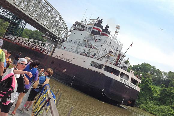 American Courage ore vessel passing under the RTA viaduct and Columbus Road Bridge