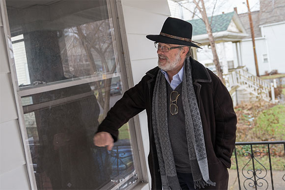 Robert Klein of Community Blight Solutions pounds on one of the SecureView window systems