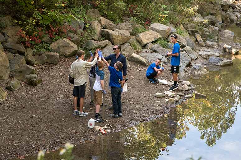 Cousteau with students water testing at the Everett Covered Bridge