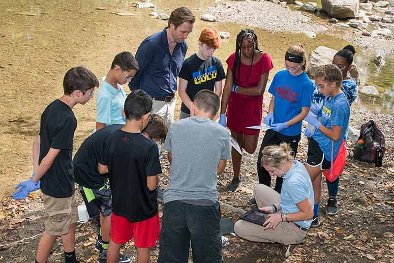 Cousteau with students water testing at the Everett Covered Bridge