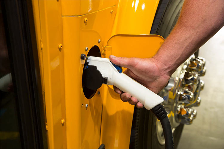 Plugging in the  electric school bus charger