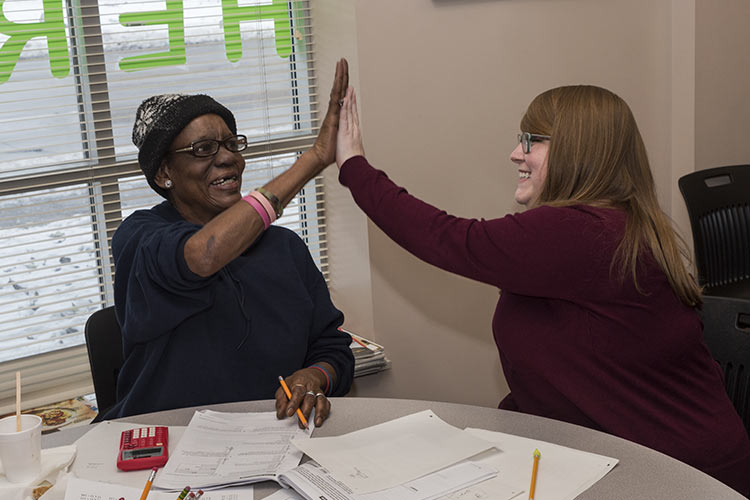 Site coordinator Kara Krawiec, high-fives a Seeds of Literacy student