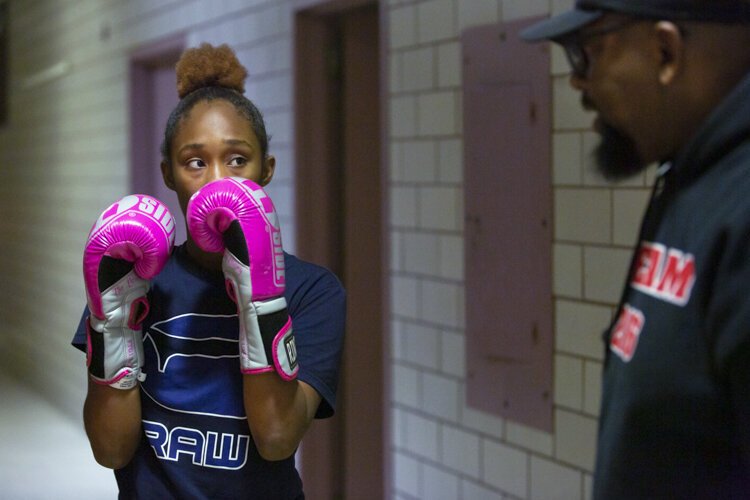Naarae, new to the Team 216 program, learns boxing basics from Coach Fred.