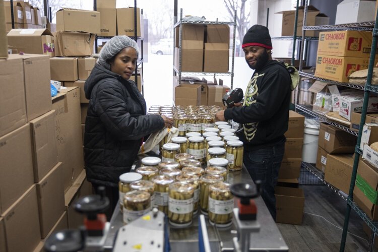 Putting the finishing touches on jars of Randy’s Pickles at Central Kitchen.
