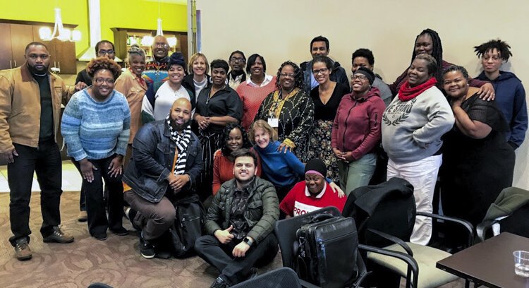 Participants in a reverse ride-along of Cleveland's Central neighborhood pose for a group photo during a stop in November.