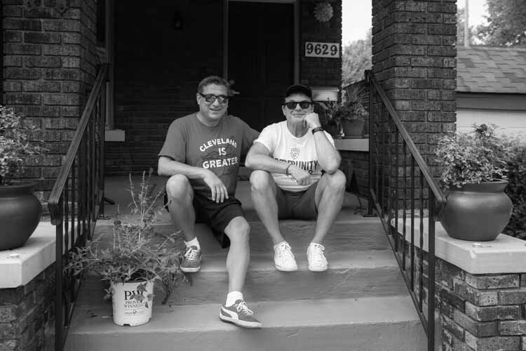 Todd Barr and Dane Vanatter on the front steps of their home in Glenville