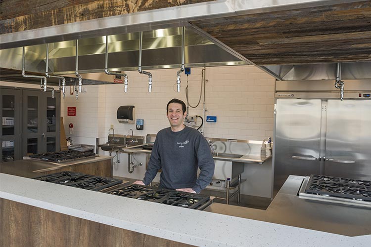 Aaron Saltzman in the modern teaching kitchen where partners will offer free community classes