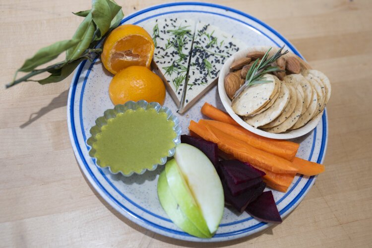 Baba Yaga’s cheese plate - House made Vegan Gluten Free/ Soy free / Nut free Smoked Provolone with a Carrot top pesto, gluten free crackers, satsuma orange, almonds, carrots.