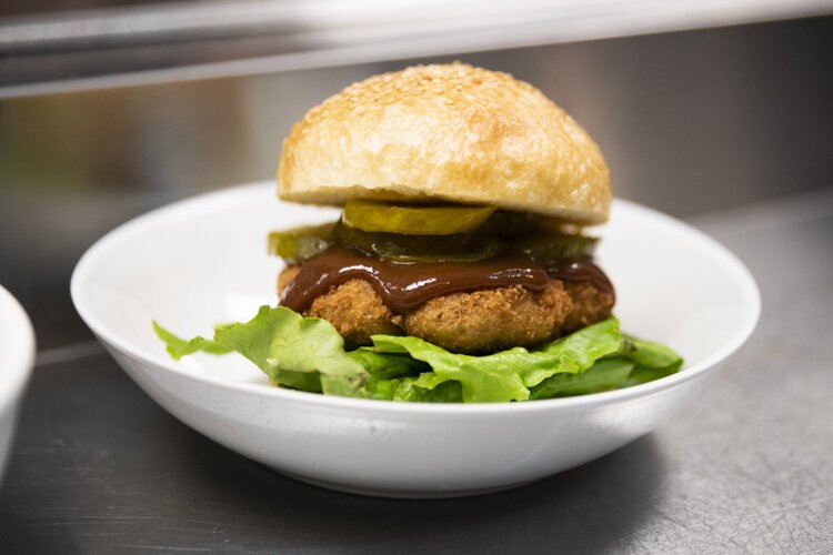 Foodhisattva’s Chick'n Katsu Sando - housemade panko-crusted Chick'n cutlet (tofu base), tonkatsu sauce, pickles, lettuce, and Japanese hot mustard mayo on a blackbird Bakery focaccia burger bun.