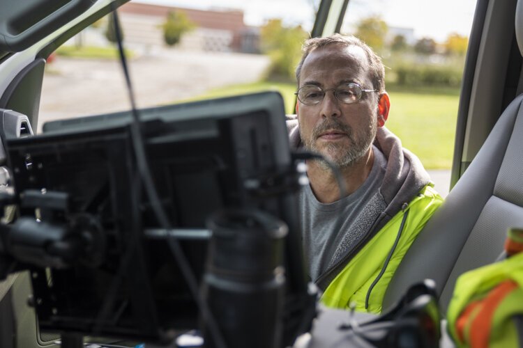 Wyatt Newman, who has training in robotics, mechanical engineering and electrical engineering, sets up the software that runs the robotic arm during a recent test.