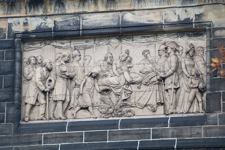 This relief on the exterior of the James A. Garfield Memorial depicts his death bed scene when he was assassinated in 1881.