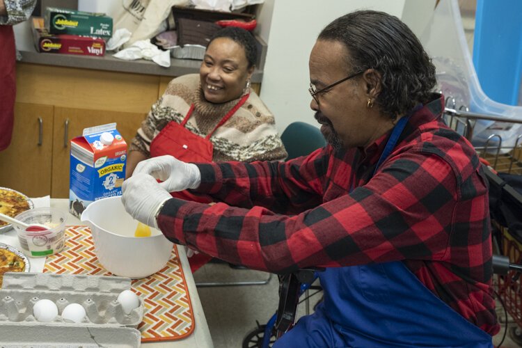 A Cedar High Rise senior prepares the ingredients for a healthy quiche.