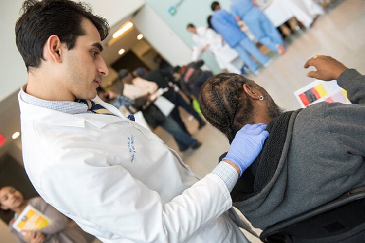 A man gets a health screening during the 2019 Minority Men’s Health Fair at the Cleveland Clinic.