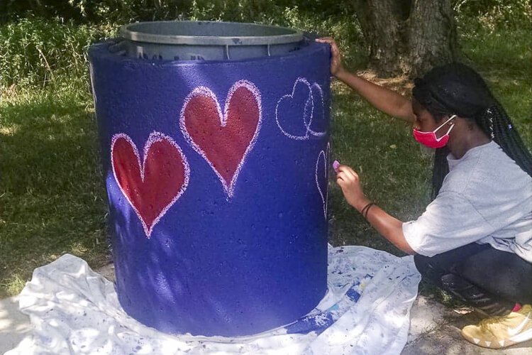 Teenagers in the Youth Opportunities Unlimited employment program doing beautification projects in the neighborhood.