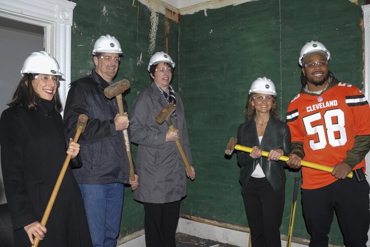 Christian Kirksey, linebacker for the Cleveland Browns (far right) at the groundbreaking for the renovation of Bonna house.