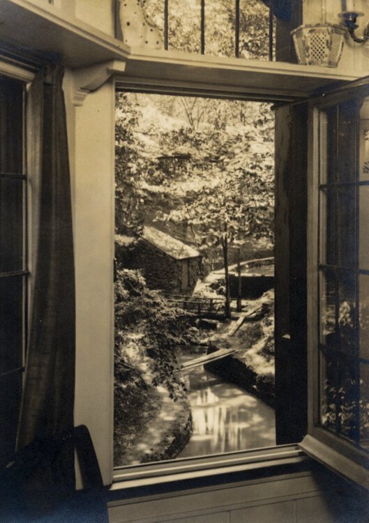 Historical photo of the view from a second floor window in the Deming House that overlooks the rear garden and the creek below.