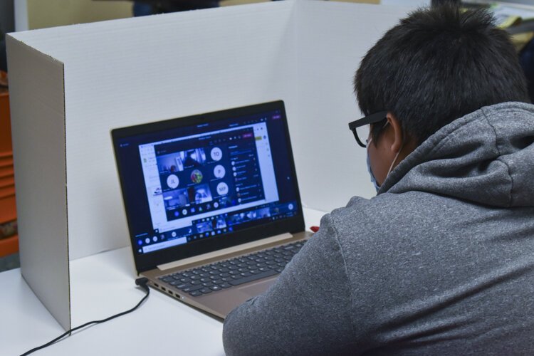 One of the CMSD students does his classwork at a learning pod inside Esperanza’s offices in Cleveland.