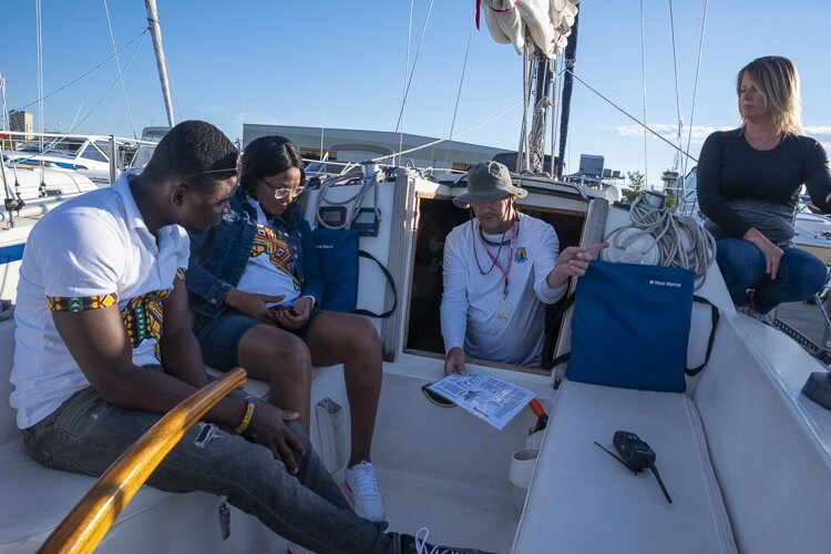 Charlotte and Emmanuel get a pre-sail crash course on sailing from Captain Scott. 