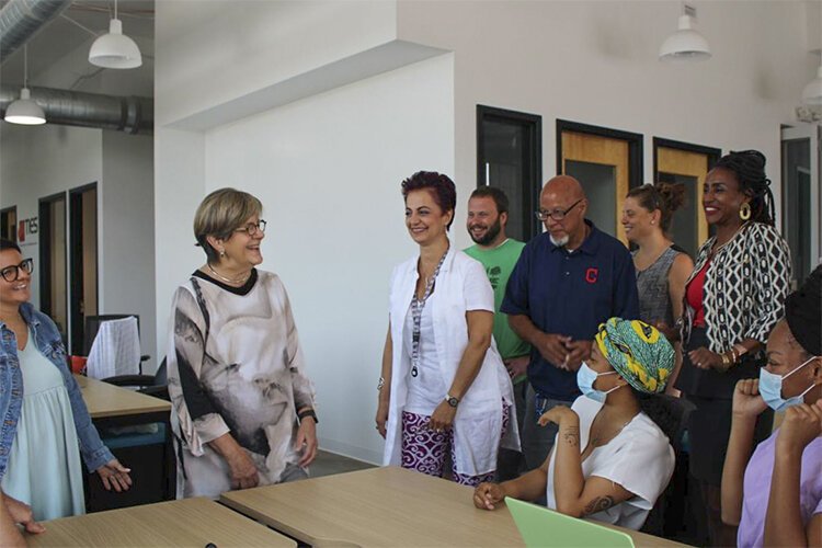 DigitalC CEO Dorothy Baunach (center with glasses) smiles with members of the DigitalC staff. Baunach attributed the grant’s possibility to her staff.