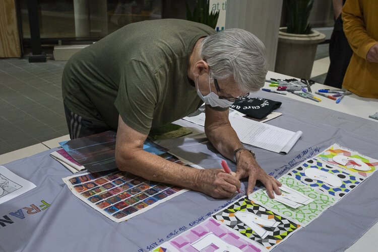 LGBTQ+ artists of CONVERGE participate in the quilt dedicated to all the LGBTQ+ artists that have died of AIDS at the MetroHealth Reception.
