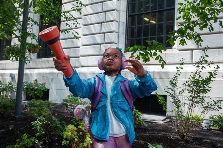 Darius Steward’s first three-dimensional artwork of child-sized sculptures in the likeness of his own children on display called “In Search of New Beginnings” in the Eastman Reading Garden at the Cleveland Public Library.