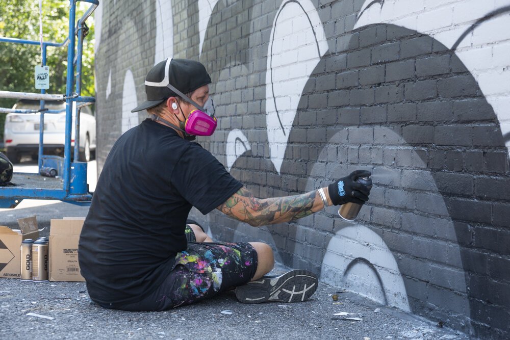 Artist Jet Martinez from Oakland, CA painting his mural at 3038 Payne Avenue