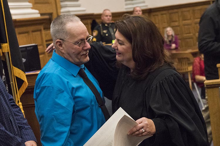 Stark County Common Pleas Judge Taryn Heath gives a certificate and hug to graduate Timothy Spickler.