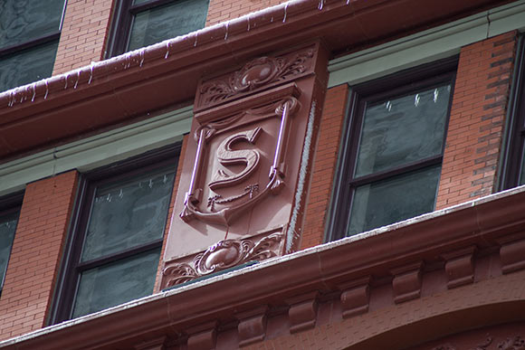 Shields with letters that spell out “Schofield” recreated and line the building