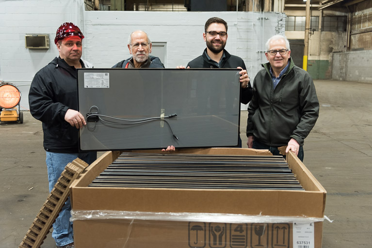 L To R: Frank Oriti warehouse manager, Gene Ameduri of Enerlogics, Reid Singer, IGS Solar Project Coordinator and Mike Foley on Director of Sustainability