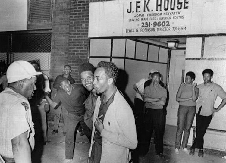 Negro youths heckle police on the East Side's Superior Ave. outside the Jomo Freedom Kenyatta Club (J.F.K. House).