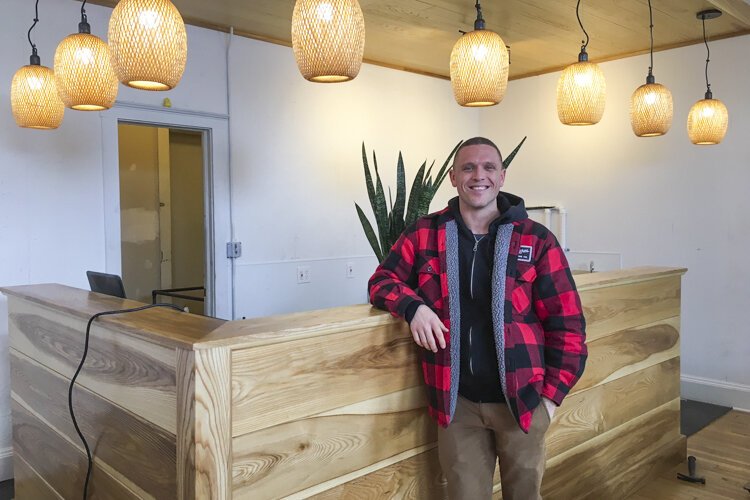 Peter Brown shows off the coffee bar inside the new Six Shooter space.