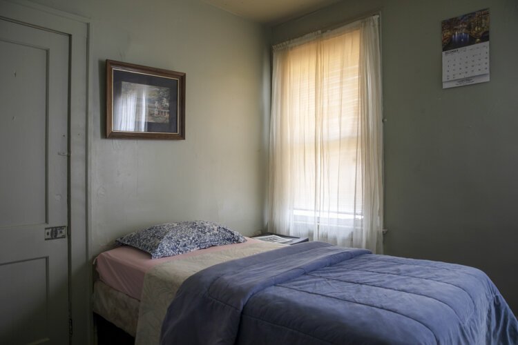 A simple and comfortable bedroom is provided at the men's shelter across the street from the Manna House.