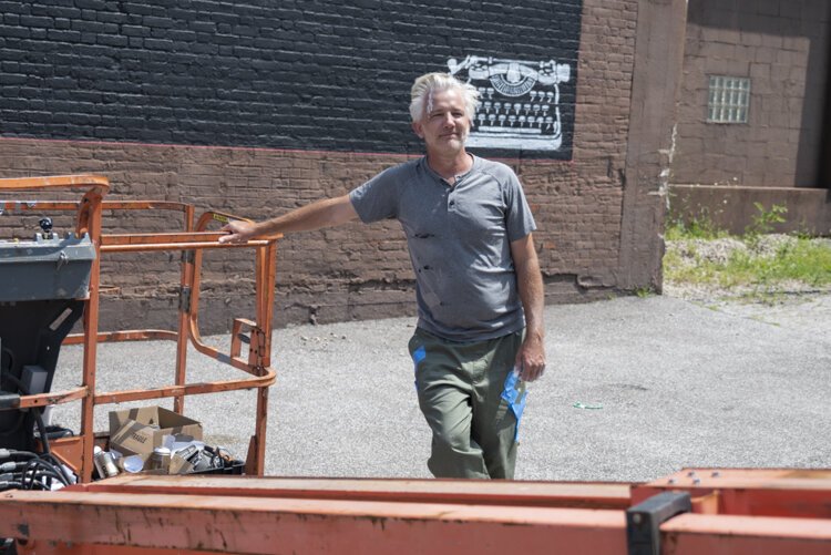 Cleveland native and Los Angeles-based street artist WRDSMTH just after finishing his “Lover” Micheal Stanley tribute mural on Payne Ave.